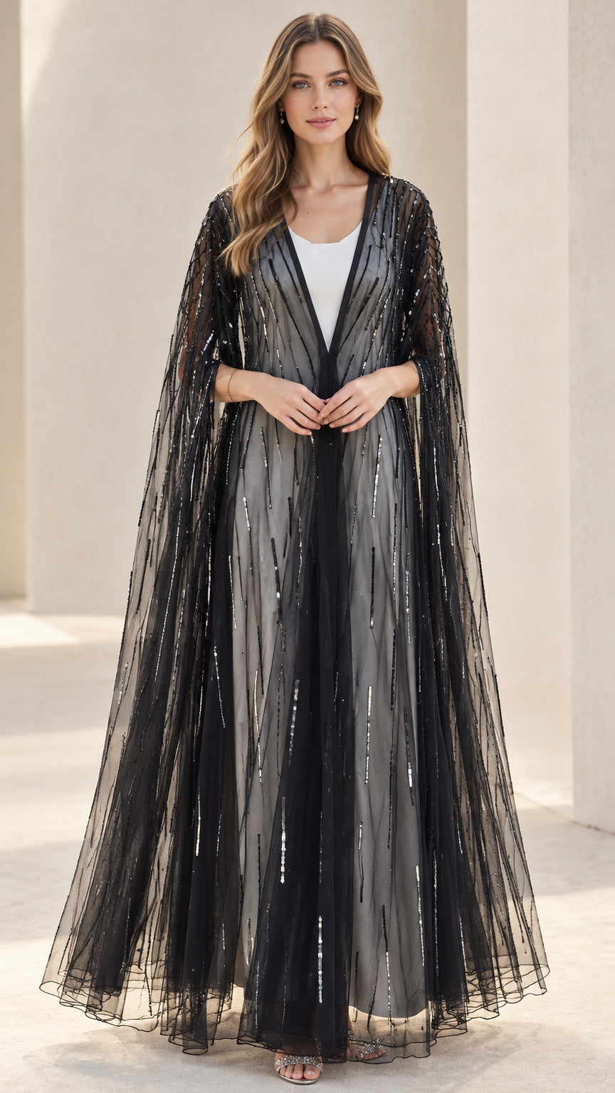 Front view of black sequin floor-length evening cape on model