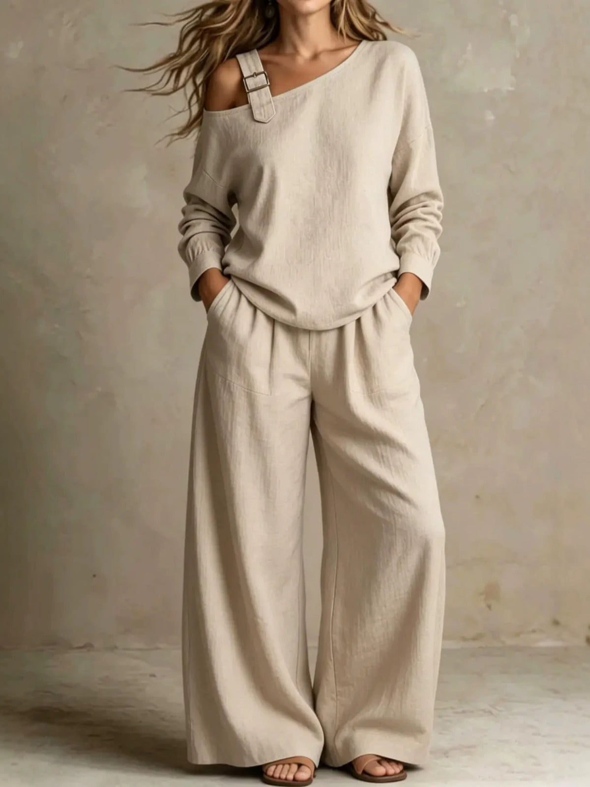Woman wearing beige asymmetric buckle top and wide-leg pants lounge set