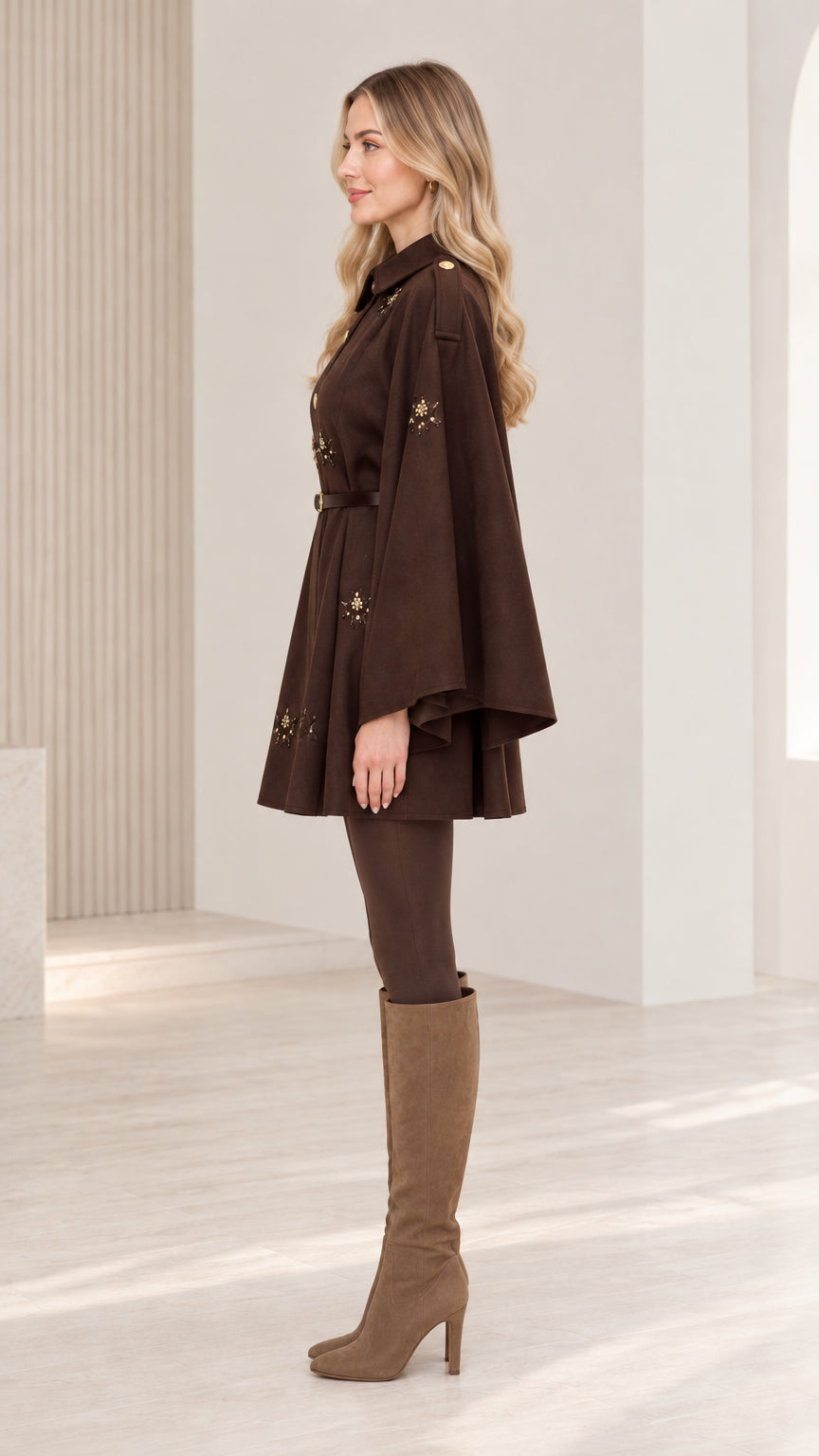 Side profile of woman showcasing flared sleeve silhouette of chocolate brown cape coat