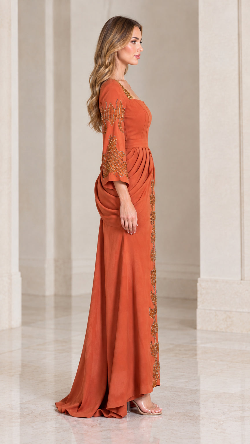 Side profile view of rust orange long sleeve formal gown showing draped waist