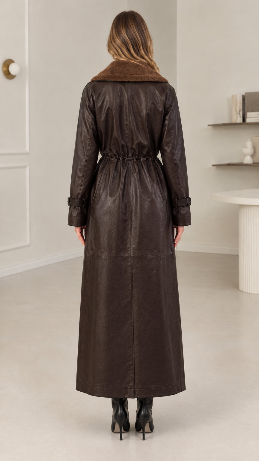 Back view of model showing cinched drawstring waist on dark brown maxi coat