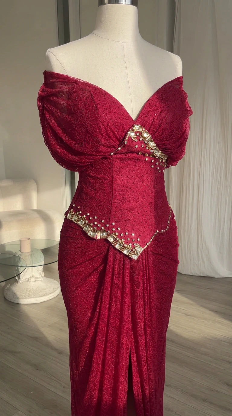 Close-up mannequin view showing rhinestone trim on basque waist and neckline of burgundy dress