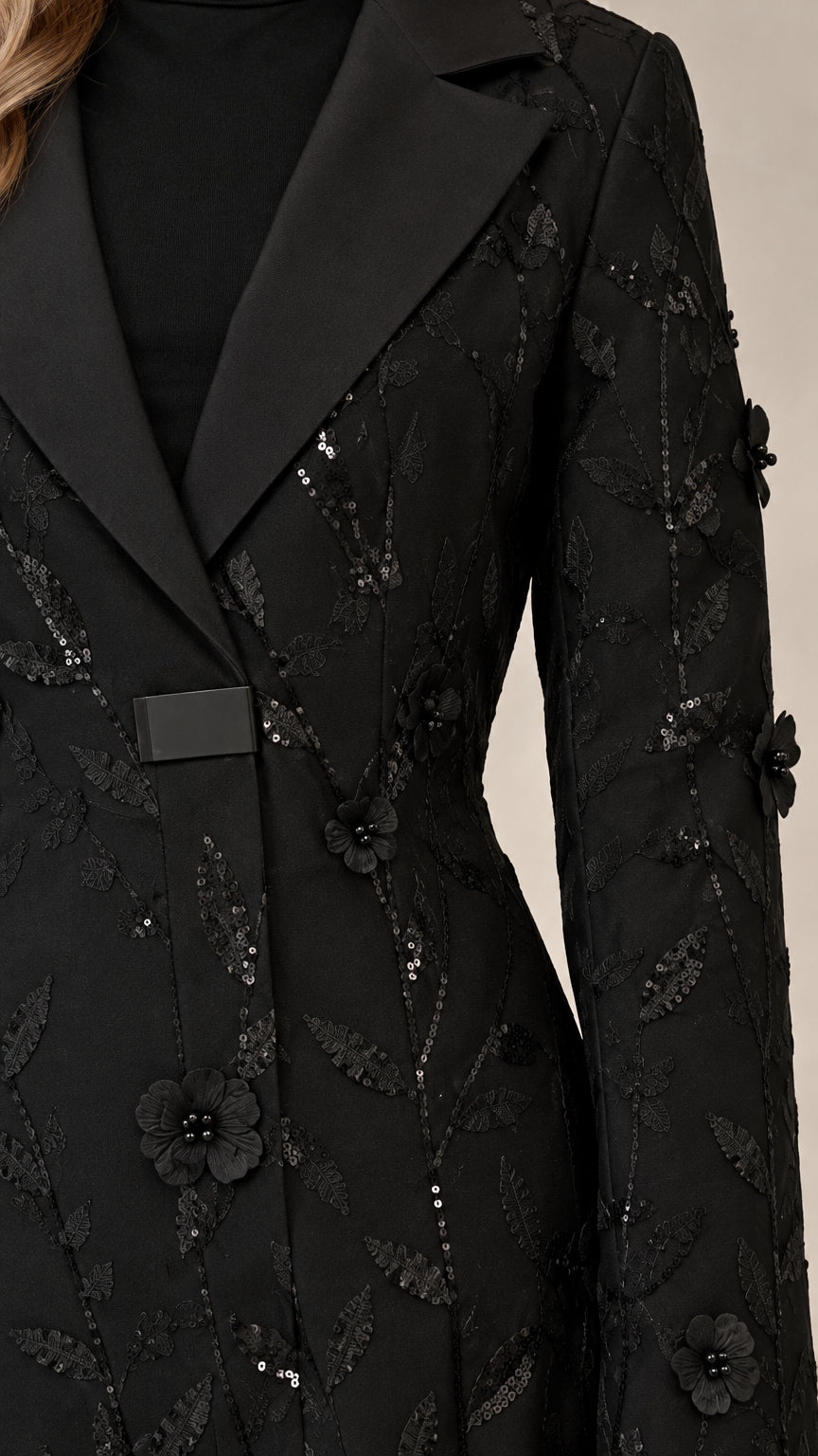 Close-up detail of black satin lapel and 3D floral sequin embroidery