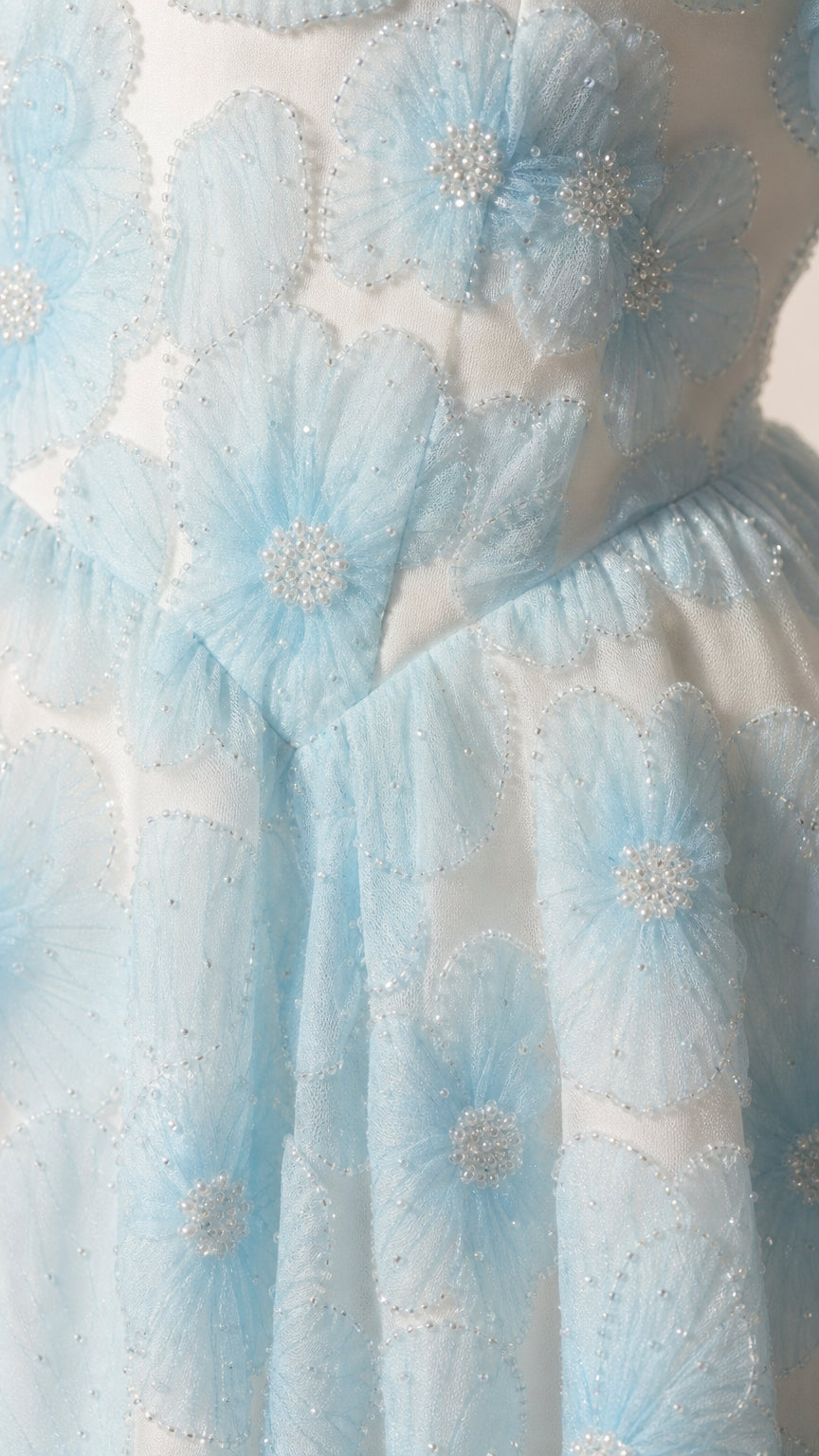 Close-up of 3D floral appliques and beading detail