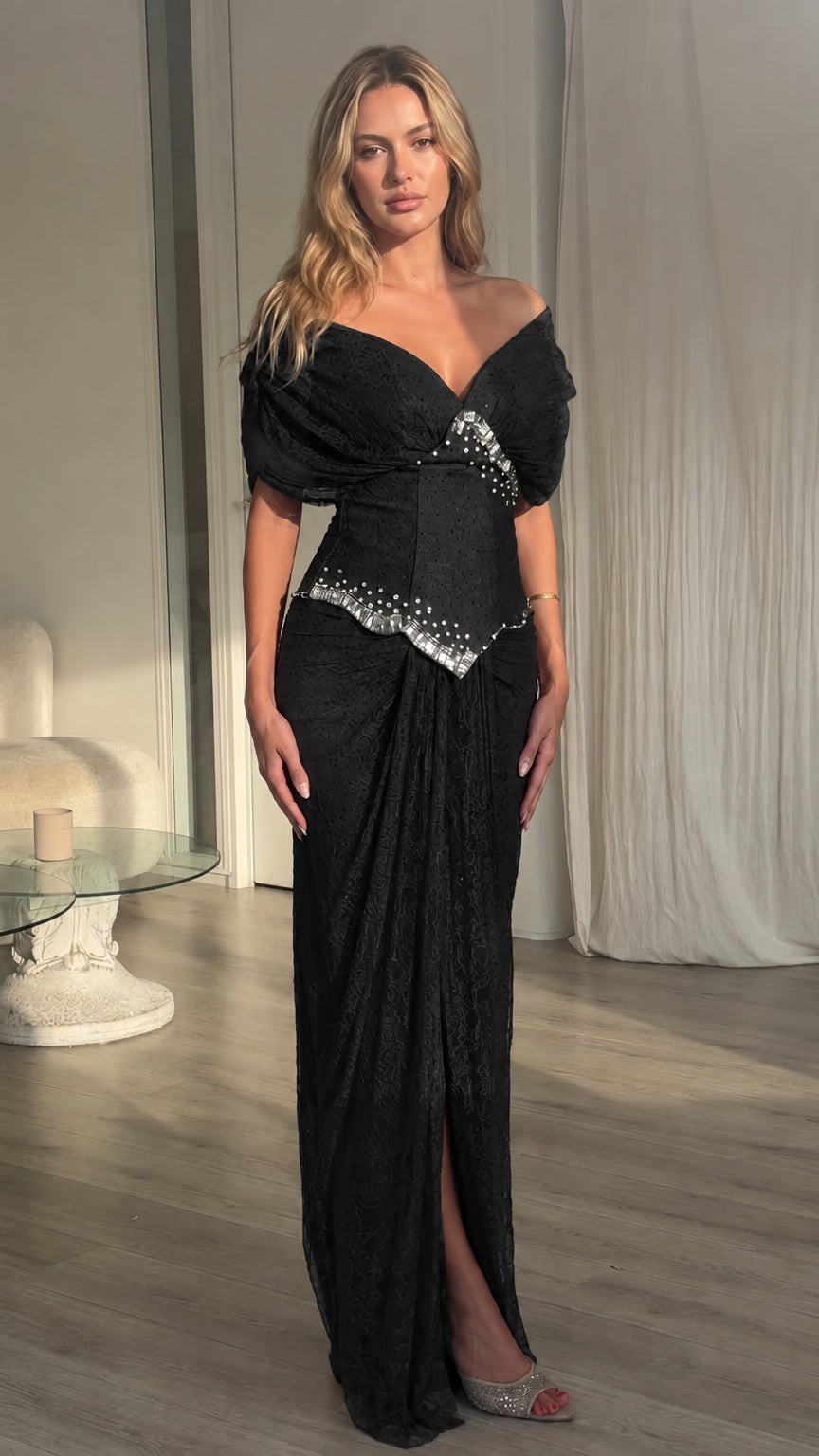 Front view of model wearing black off-the-shoulder embellished maxi dress