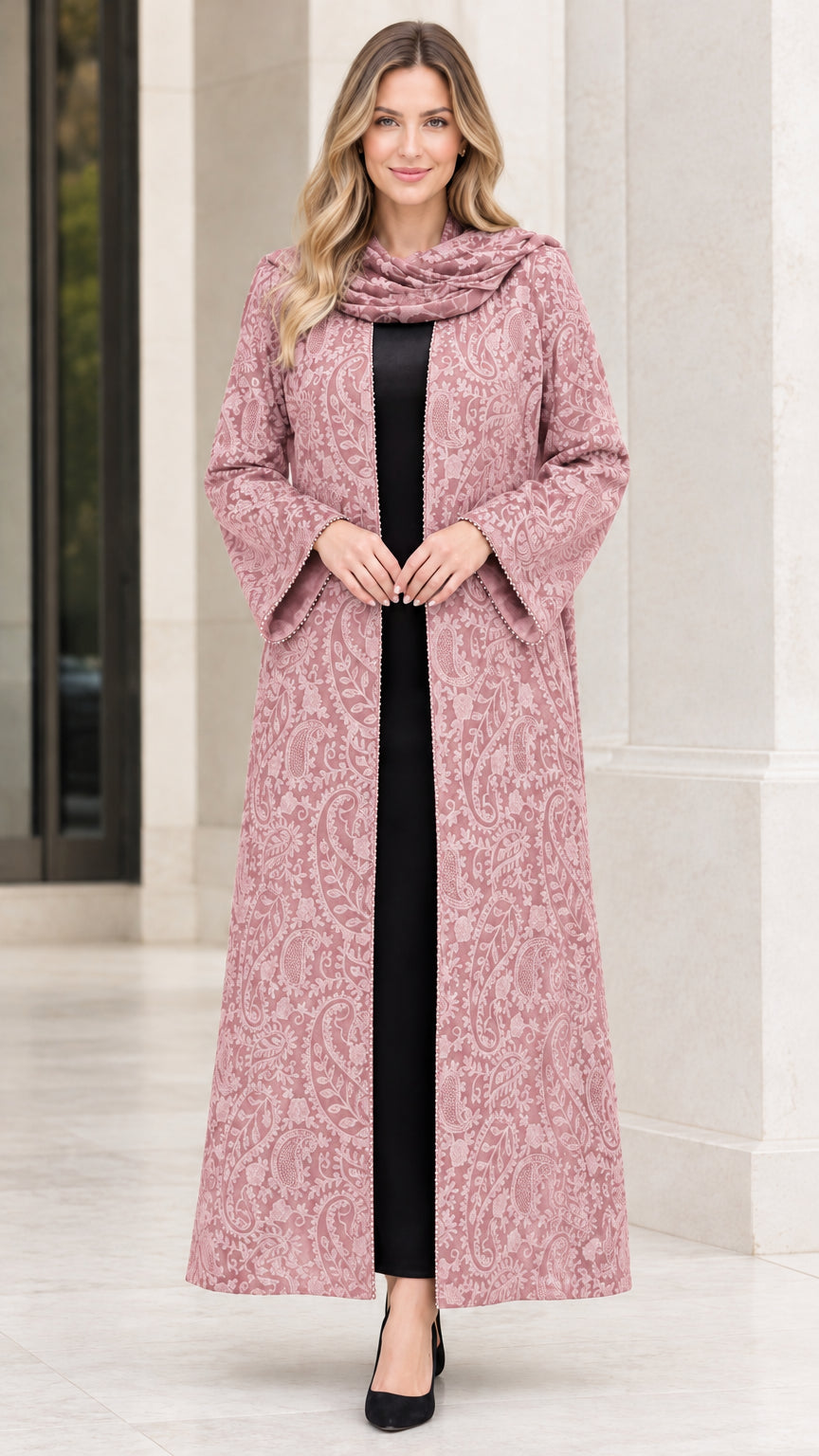 Front full-length view of woman wearing blush pink paisley jacquard maxi duster coat