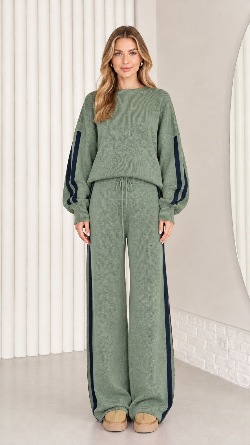 Front view of model wearing sage green knit two-piece lounge set with navy stripes