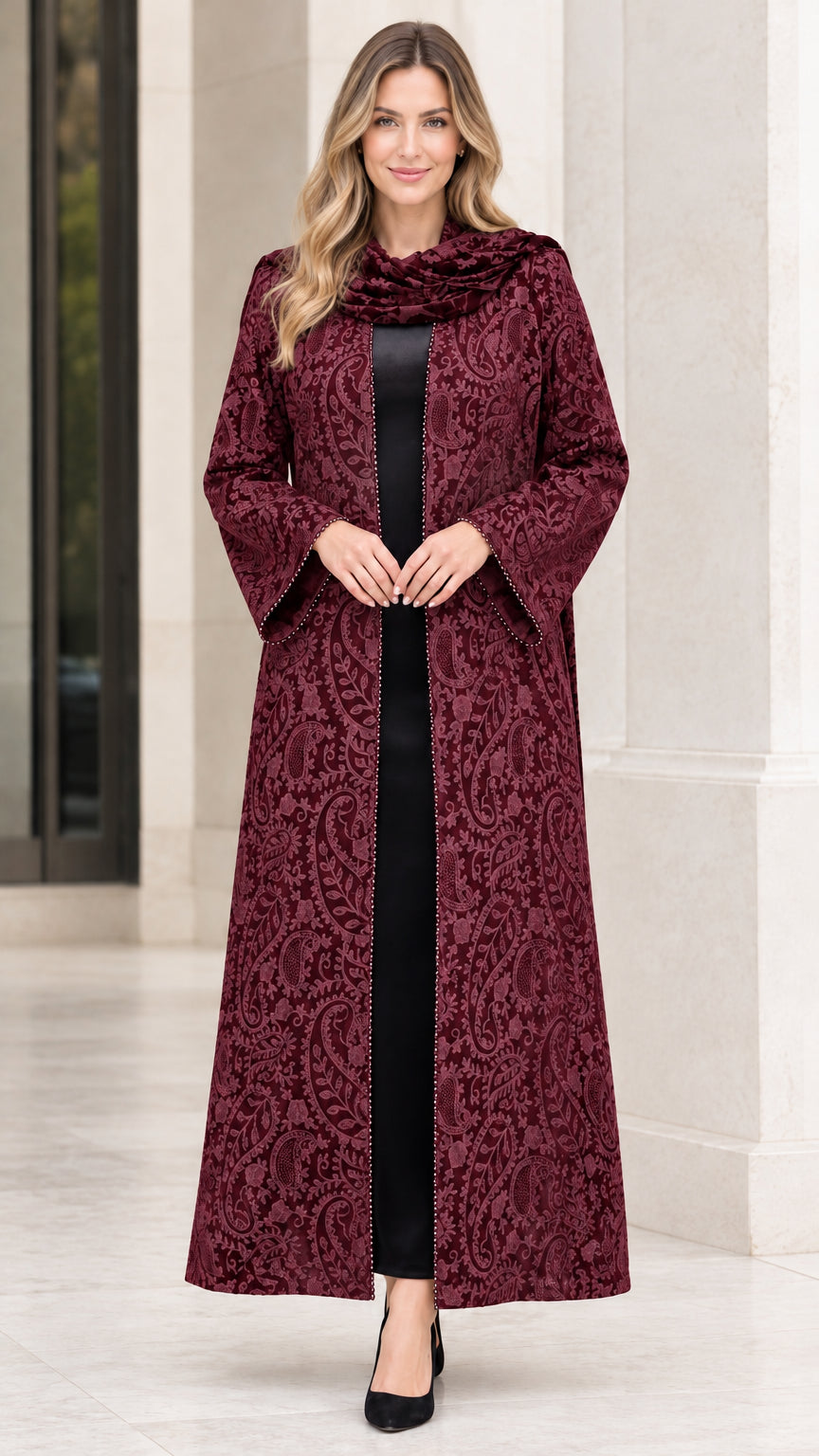 Front full-length view of woman wearing rich burgundy paisley jacquard maxi duster coat