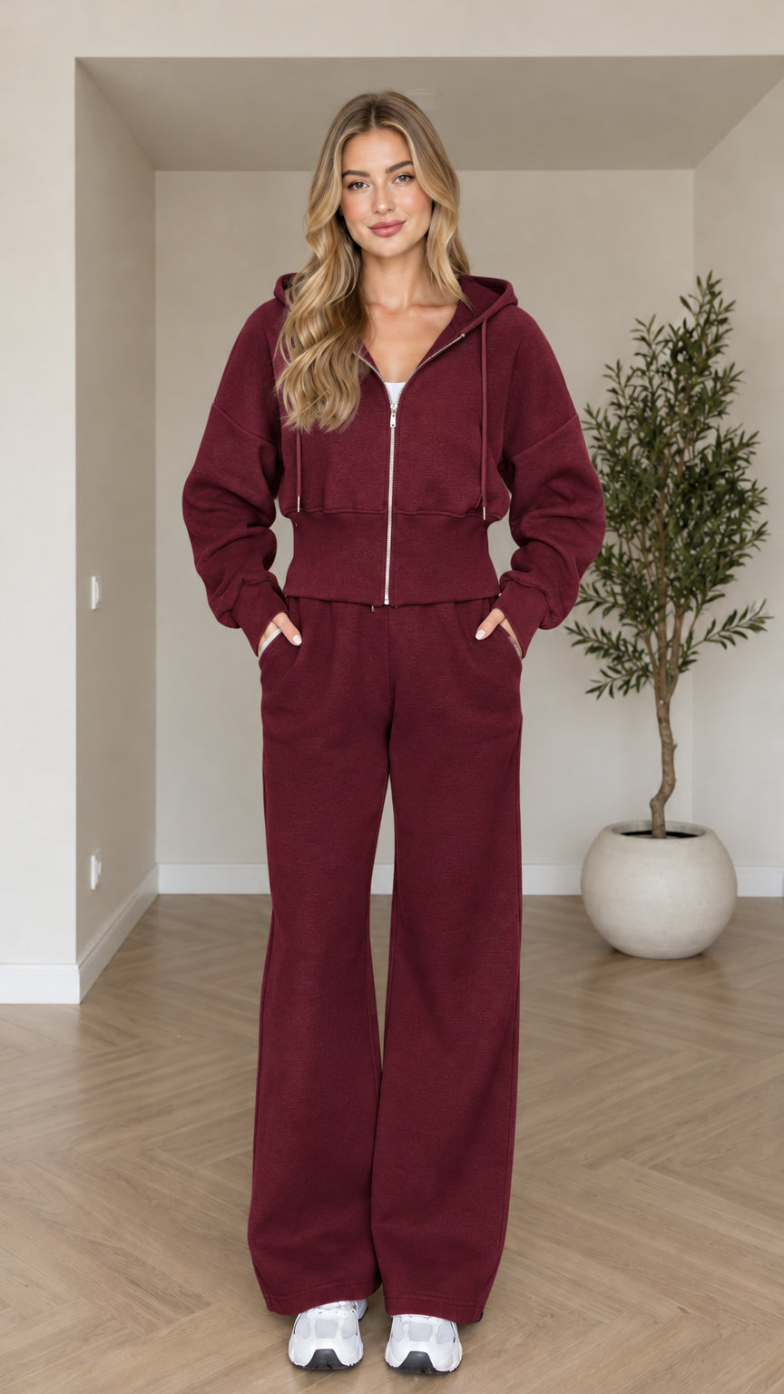 Front view of woman wearing burgundy cropped zip hoodie and wide-leg sweatpants set