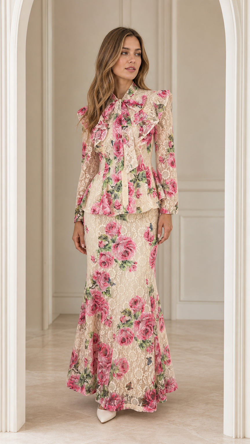 Front view of woman wearing beige floral lace peplum top and maxi skirt set