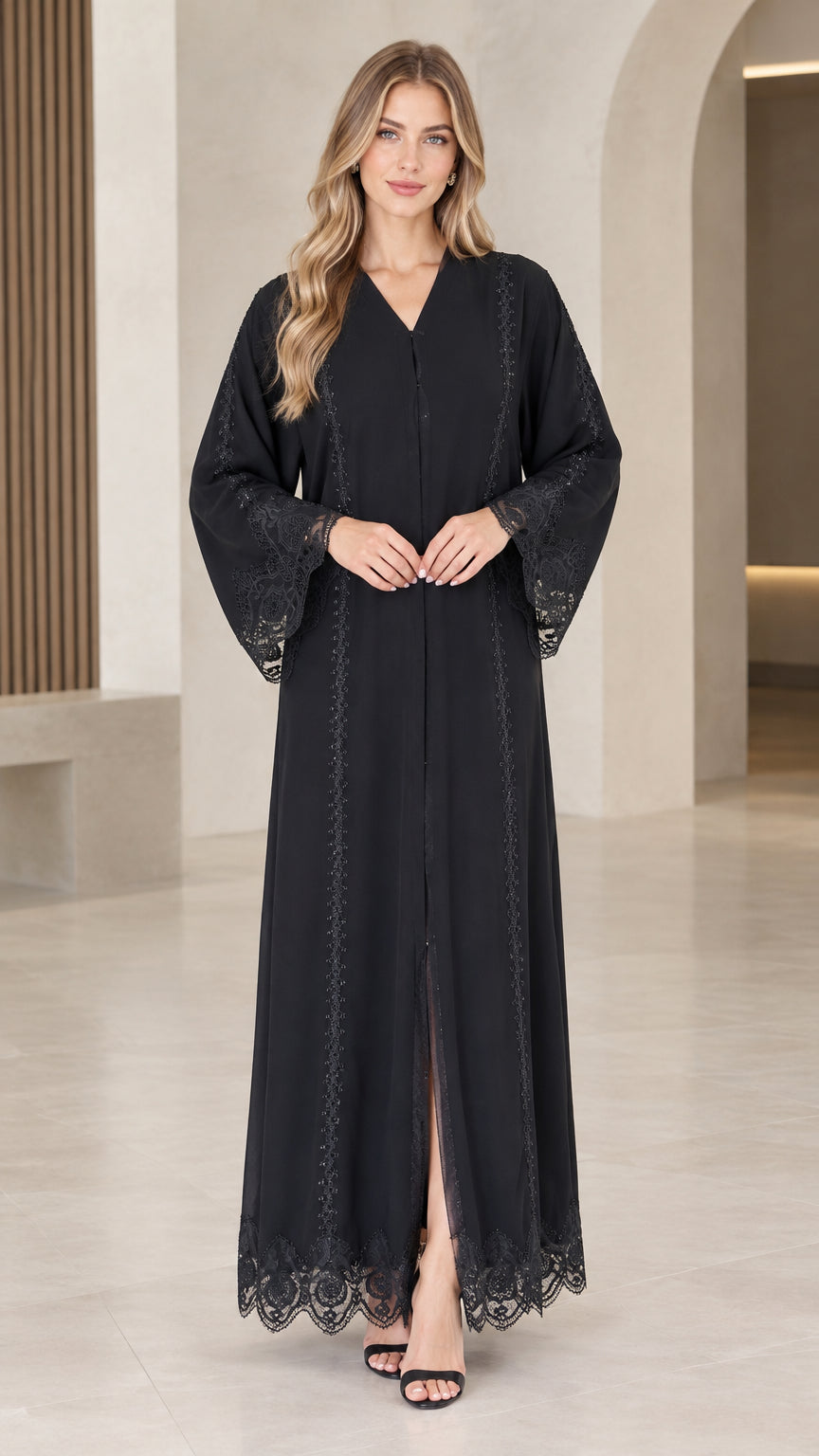 Front view of woman wearing elegant black maxi abaya dress with lace trim