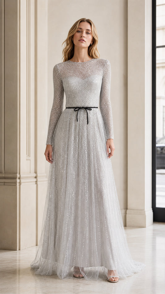 Front view of model wearing silver long-sleeve sequin tulle evening gown