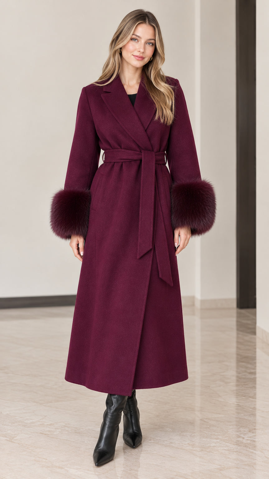 Full front view of model wearing burgundy maxi wrap coat with faux fur cuffs and tie belt