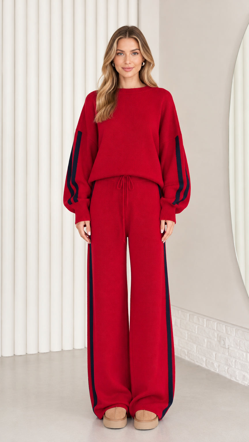 Front view of model wearing red knit two-piece lounge set with navy side stripes