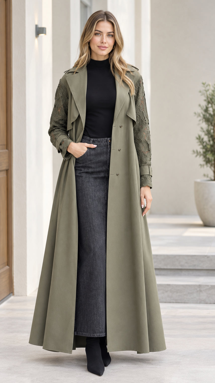Front full-length view of model wearing olive green lace-sleeve maxi trench coat over turtleneck and denim skirt