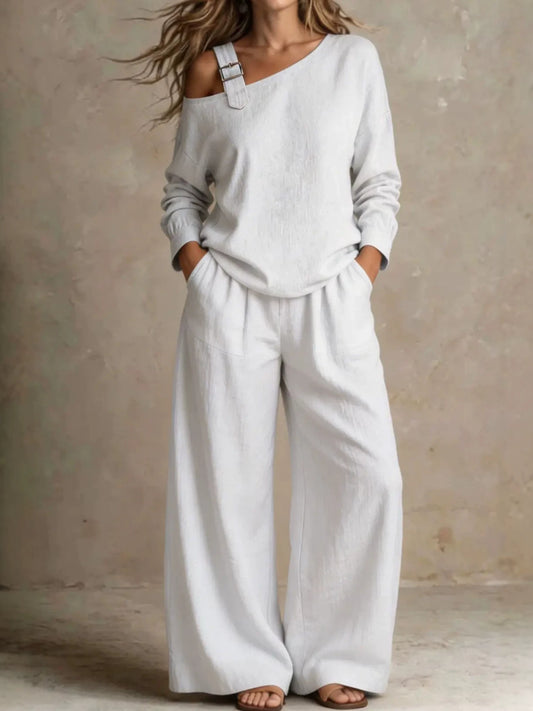Woman wearing white asymmetric buckle top and wide-leg pants lounge set