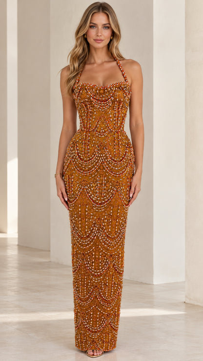 Front view of model wearing rust orange beaded halter neck column evening gown