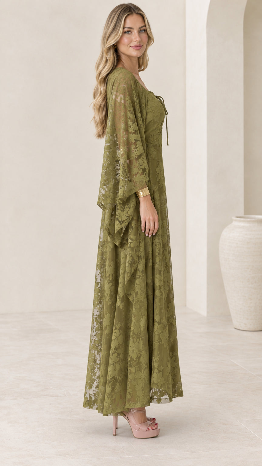 Side profile view of olive green lace maxi gown showing drape of sleeve and skirt