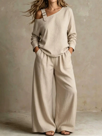 Woman wearing beige asymmetric buckle top and wide-leg pants lounge set