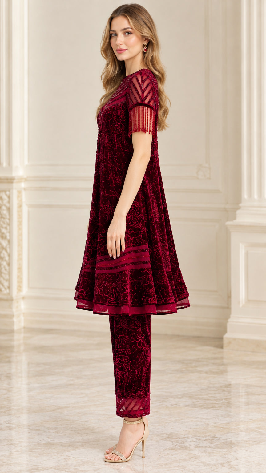 Side profile view of burgundy flared velvet tunic and straight trousers