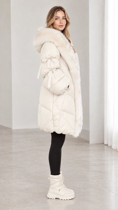 Side profile view of off white mid length hooded puffer coat