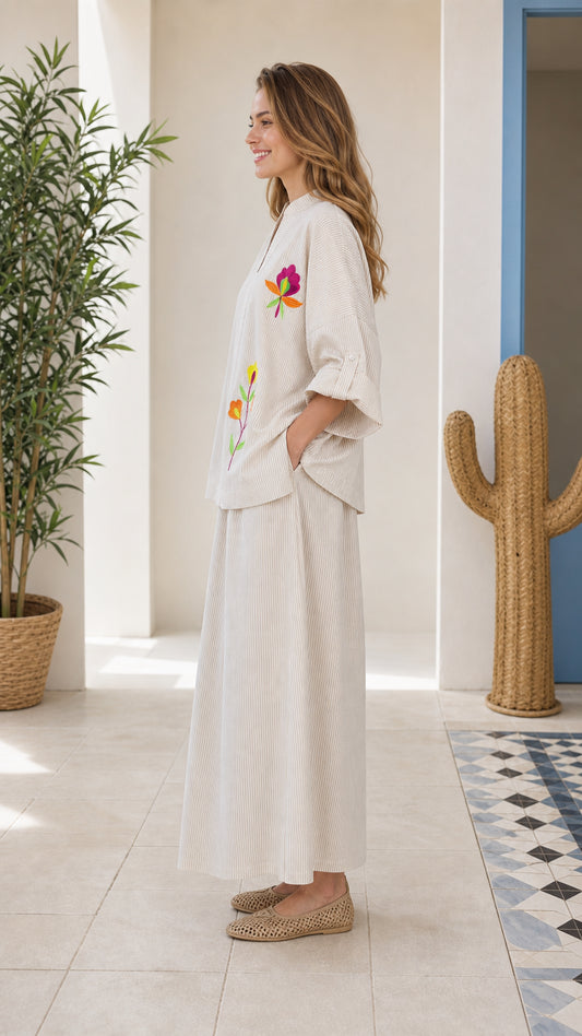 Side view of woman wearing beige embroidered two-piece set
