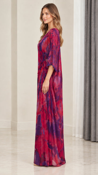 Side profile of model wearing magenta purple floral watercolor kaftan maxi dress
