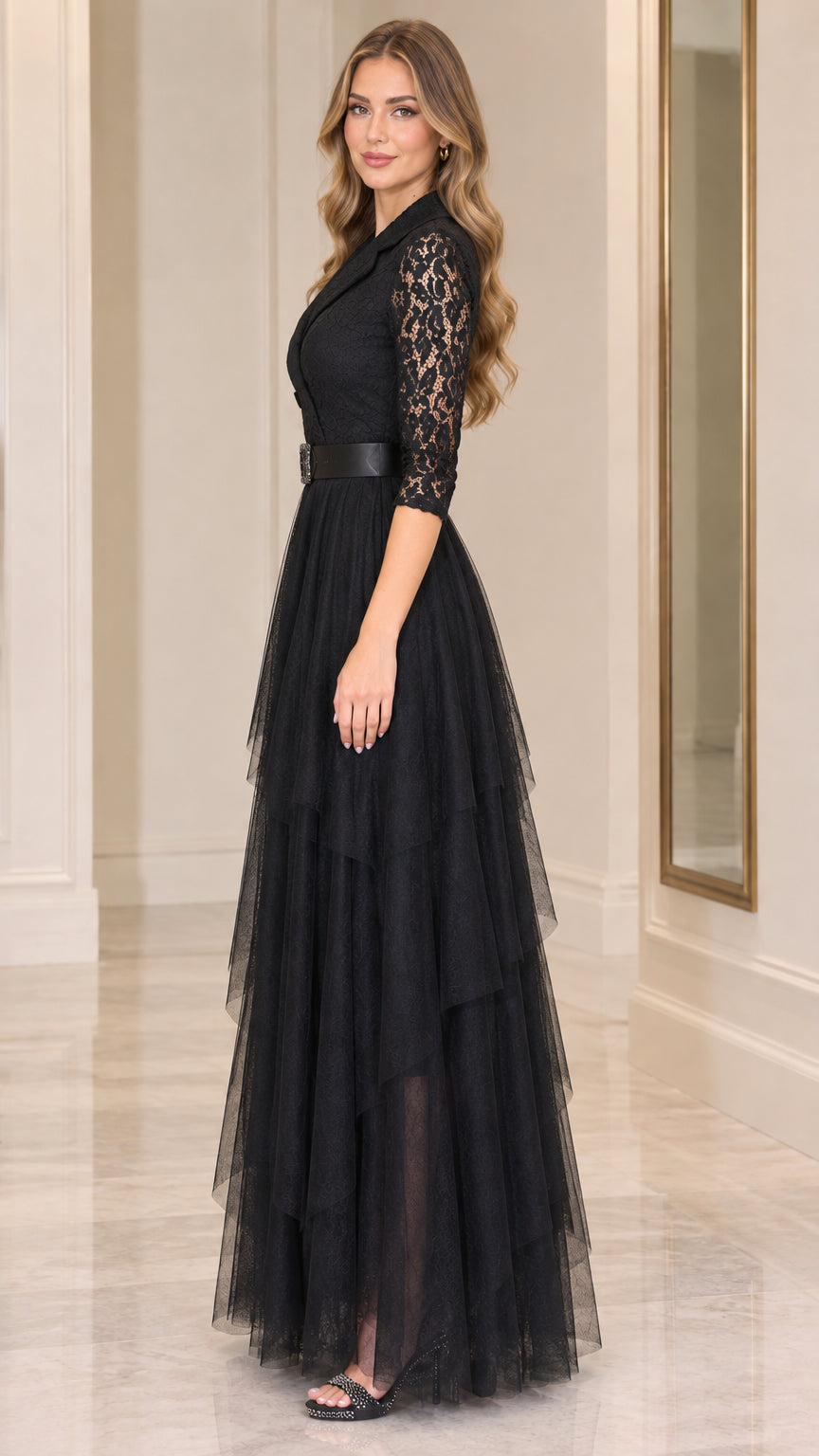 Side full-length view of model wearing black lace 3/4 sleeve tiered formal gown