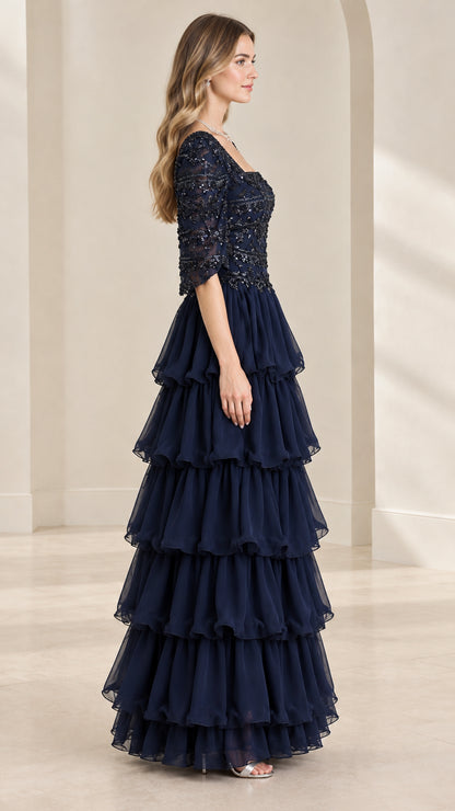 Side profile view of navy blue tiered ruffle maxi formal dress with half sleeves