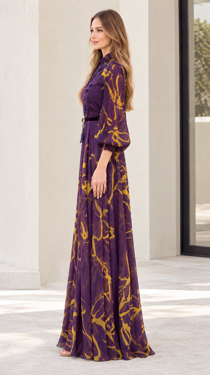 Side profile of model wearing purple floral maxi dress showing flowing skirt drape