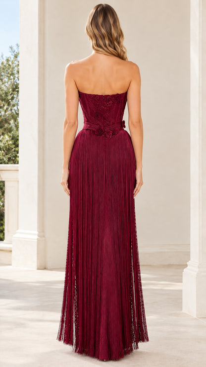 Burgundy strapless corset maxi gown back view with full fringe skirt