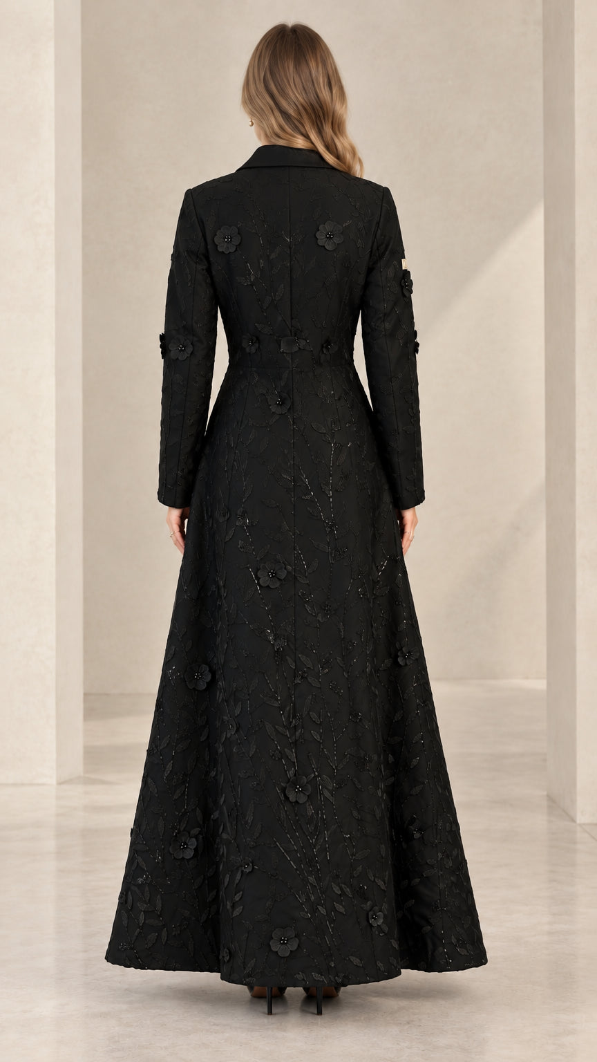 Back view of woman wearing structured black floral embroidered maxi coat