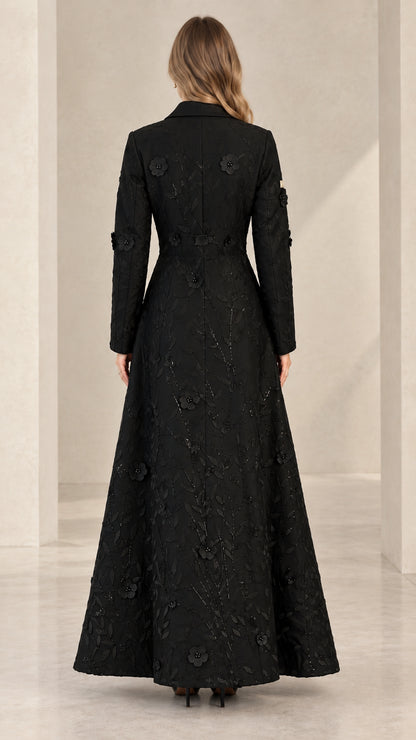 Back view of woman wearing structured black floral embroidered maxi coat