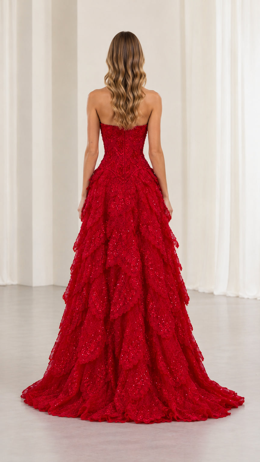 Back view of model wearing floor-length red tiered evening dress