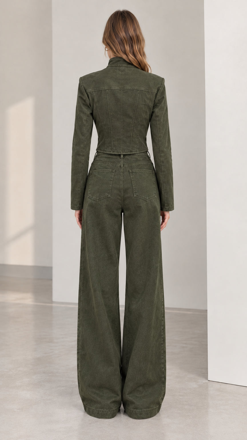 Back view of women's olive green cropped structured jacket and wide leg trousers