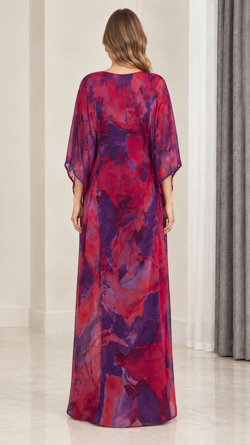Back view of model wearing magenta purple flowy watercolor kaftan gown