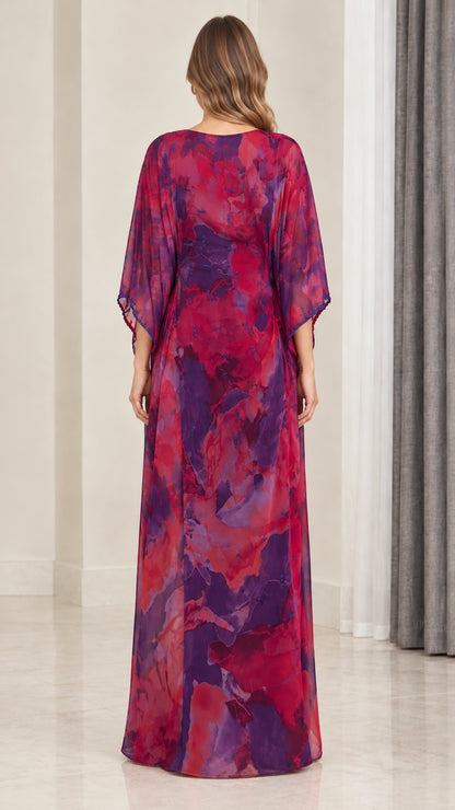 Back view of model wearing magenta purple flowy watercolor kaftan gown