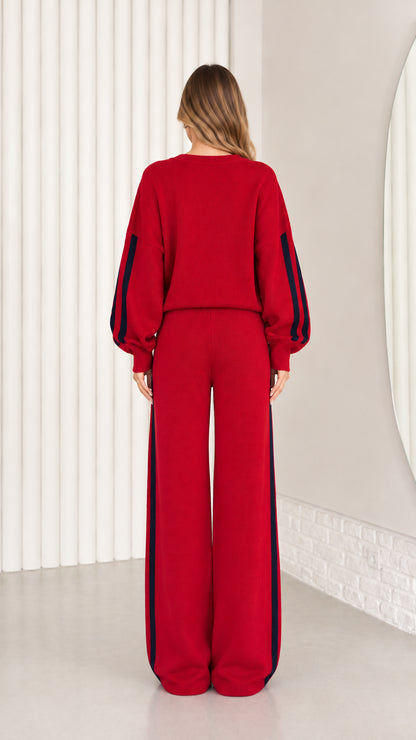 Back view of model wearing red knit two-piece matching set with relaxed fit