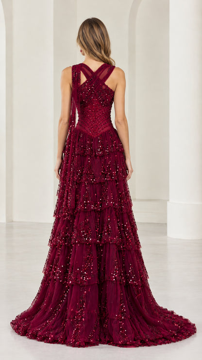 Back view of burgundy criss-cross halter formal gown showing train
