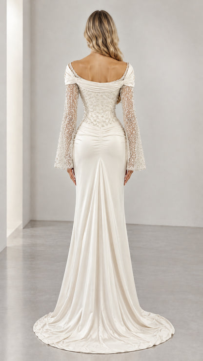 Back view of ivory formal gown featuring low scoop back and puddle train