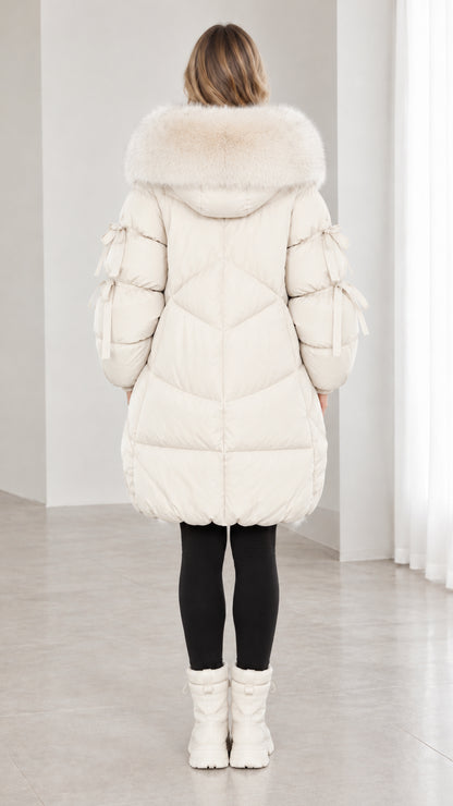 Back view of off white quilted winter puffer coat with large faux fur hood