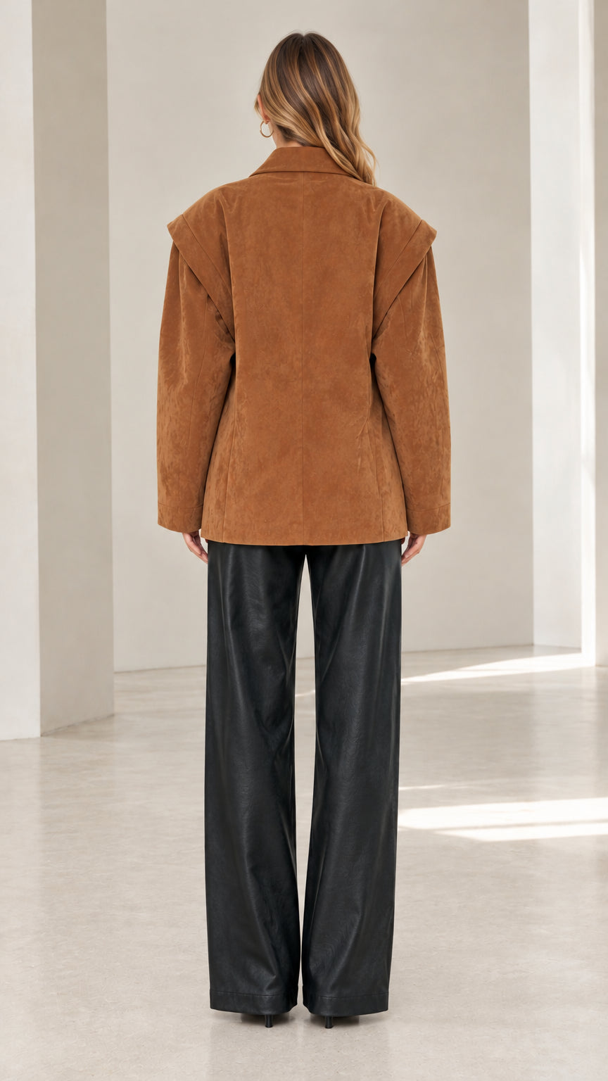 Back view of model in camel faux suede blazer highlighting shoulder overlay construction