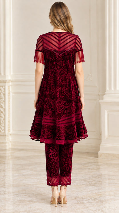Back view of model showing sheer back yoke and flared hem on burgundy tunic set