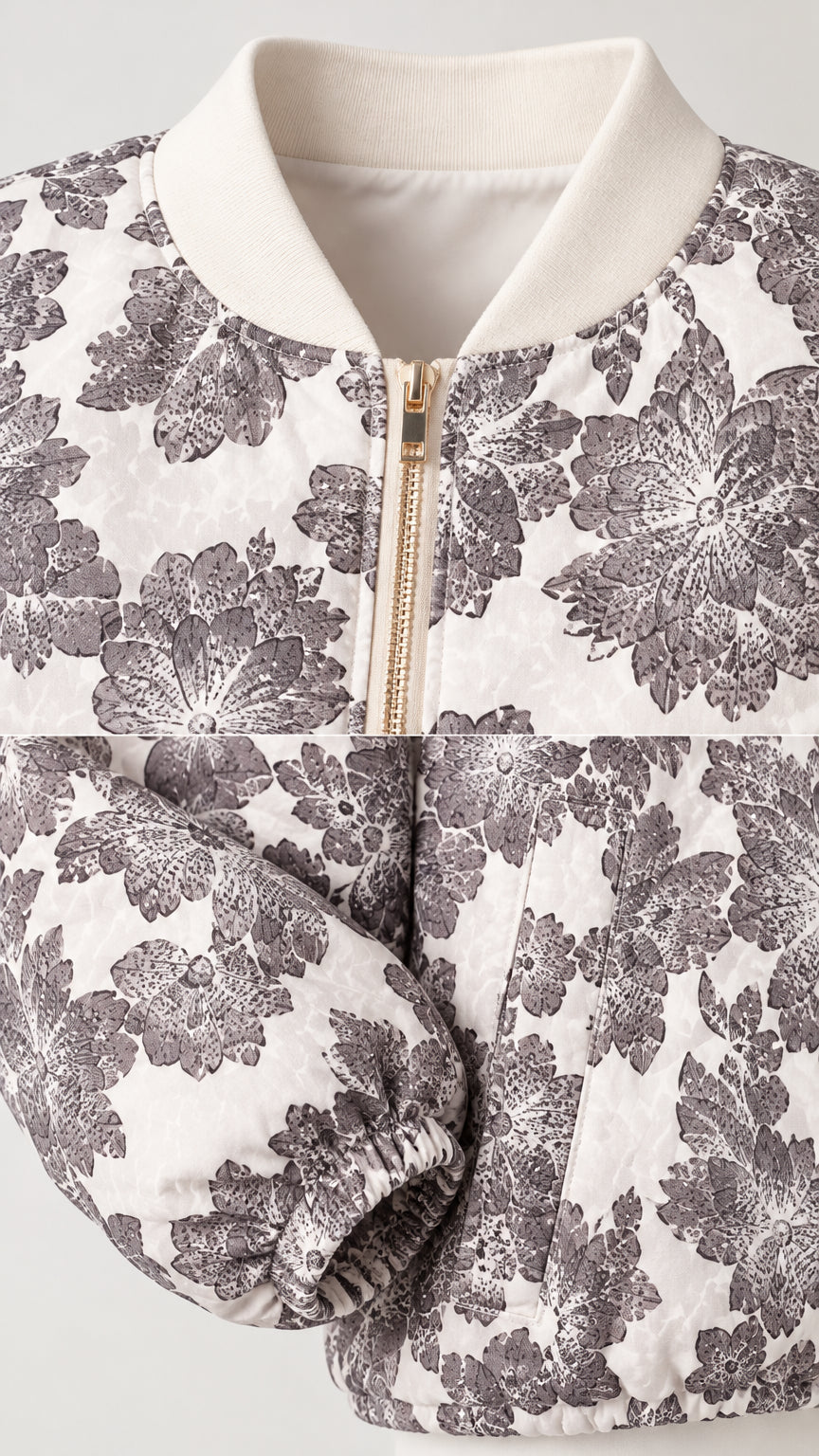 Close-up detail of ribbed collar, front metallic zipper, and floral fabric cuff