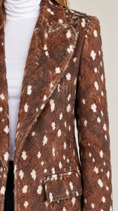 Close-up detail of notched lapel and textured spotted faux-fur fabric on brown coat