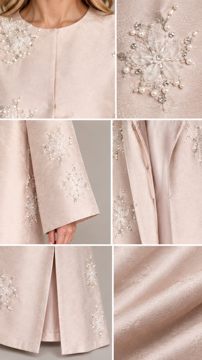 Close-up details of intricate pearl embroidery, cuffs, neckline, and fabric