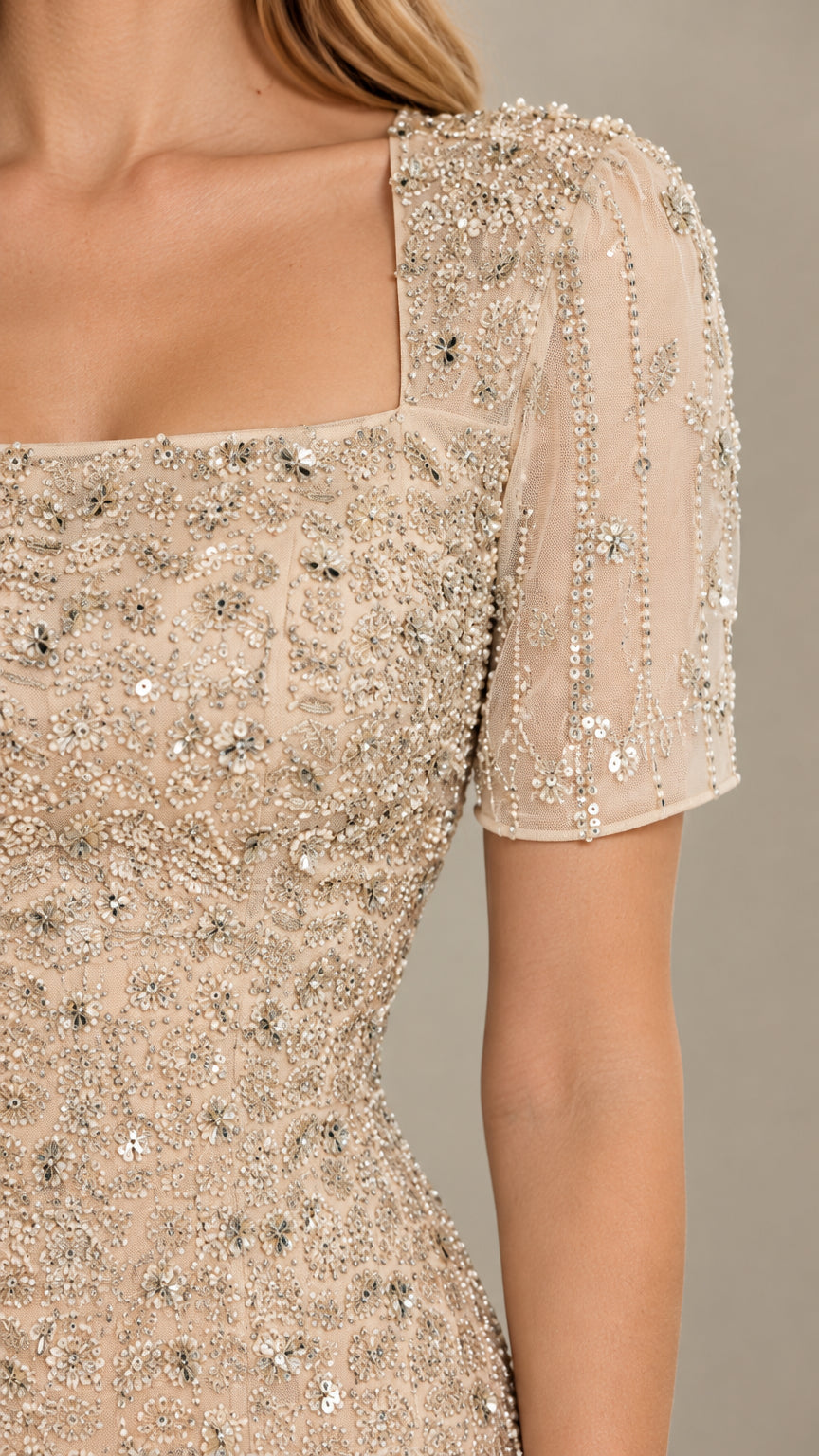 Close up of square neckline and intricate beading on short sleeve gown