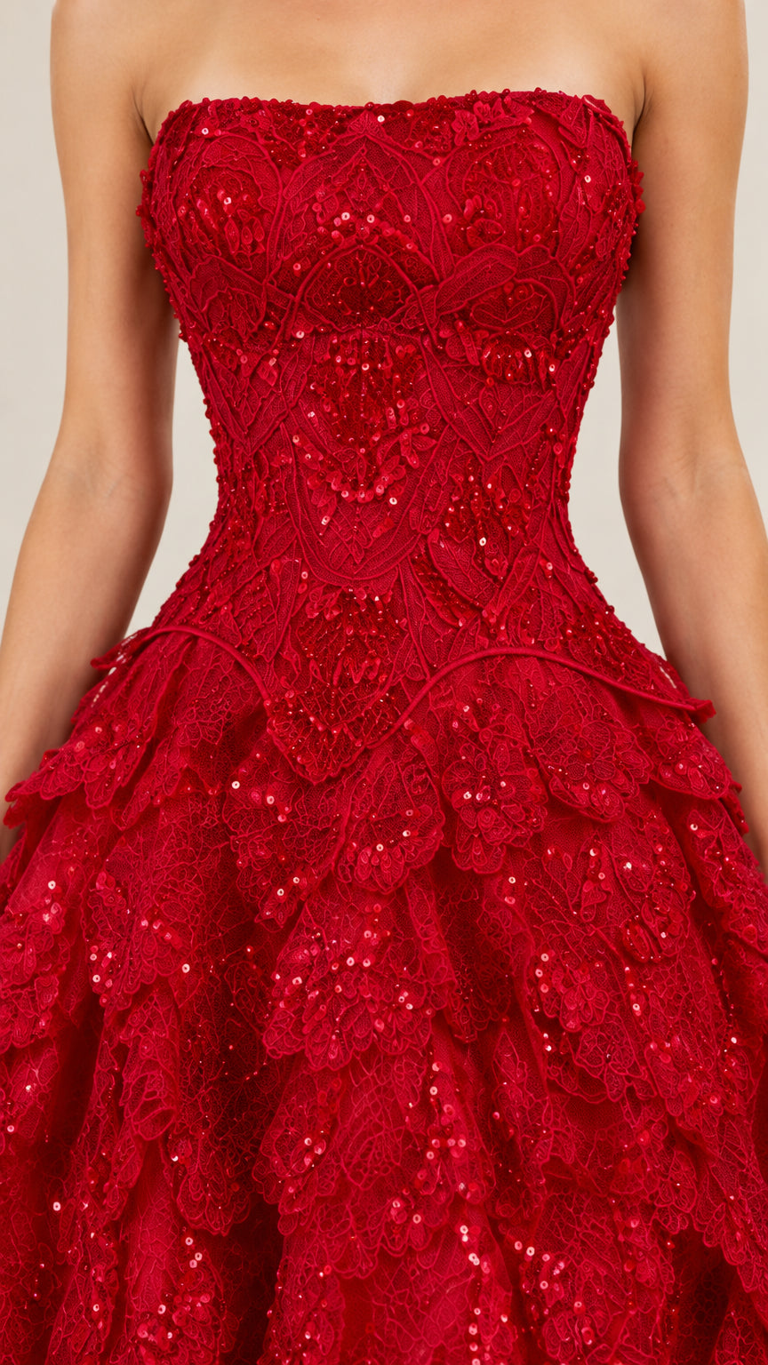 Close-up of red sequin embroidery and tiered texture on bodice and skirt