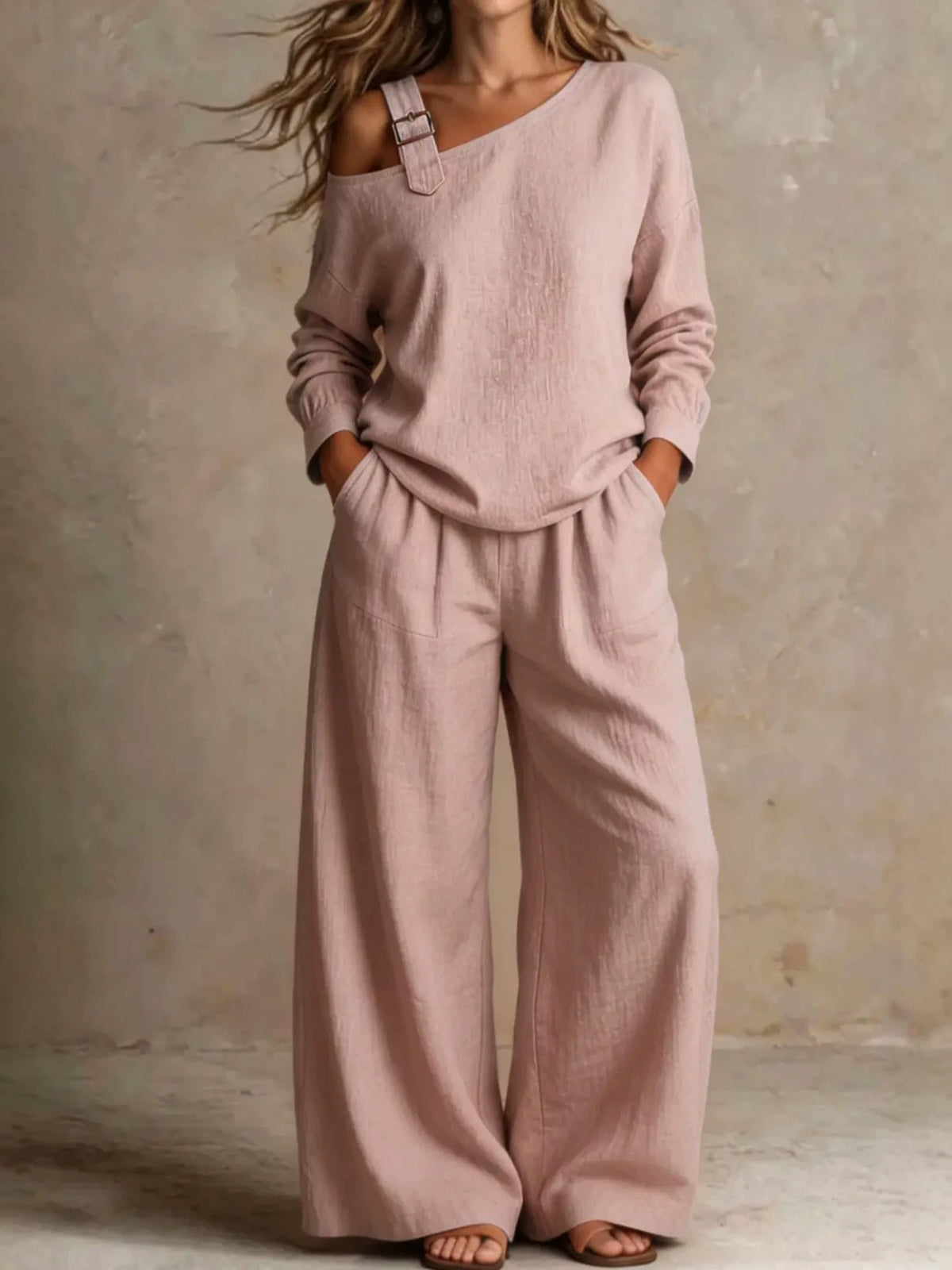 Woman wearing pink asymmetric buckle top and wide-leg pants lounge set