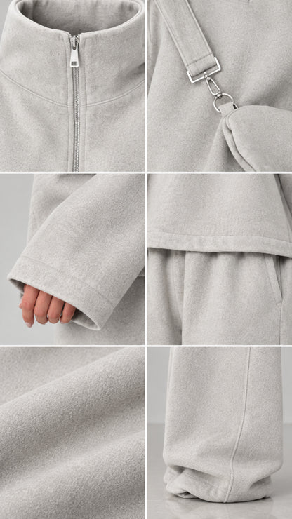 Close-up details of fleece fabric texture, zipper neckline, and pocket construction